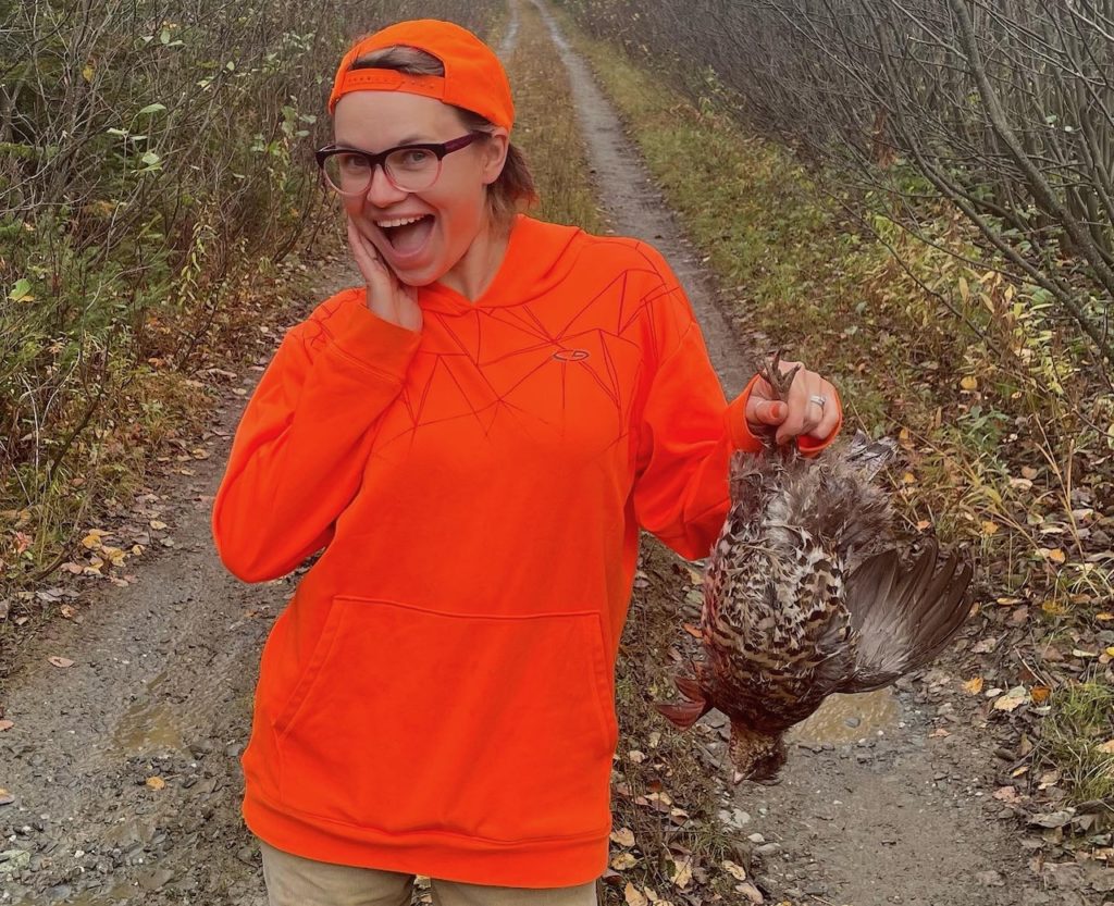 Mandy Wheaton in the north maine woods with a partridge